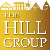 Hill Grouop logo in white to gold gradient with outlines of gold buildings and mountains on top